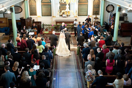 Bride and groom at the altar altar view Real Wedding Sneak Peek Katherine and Nic